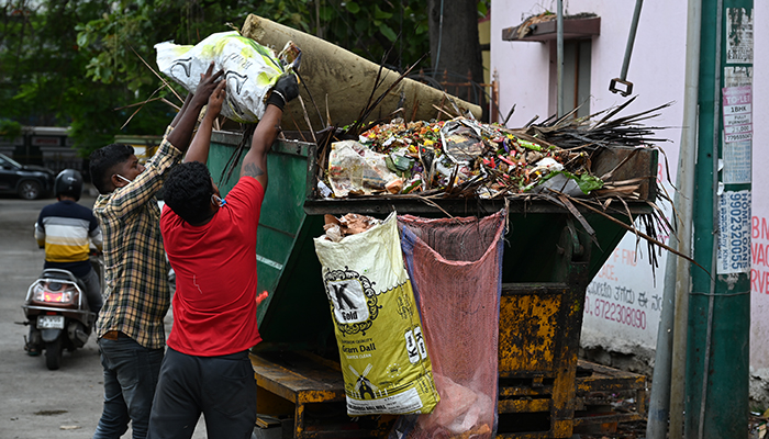 parisara workers collecting garbage